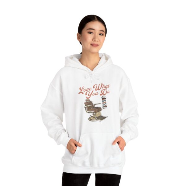 A woman wearing a white hoodie with a picture of a cat.