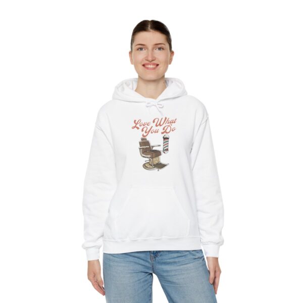 A woman wearing a white hoodie with a picture of a cat.