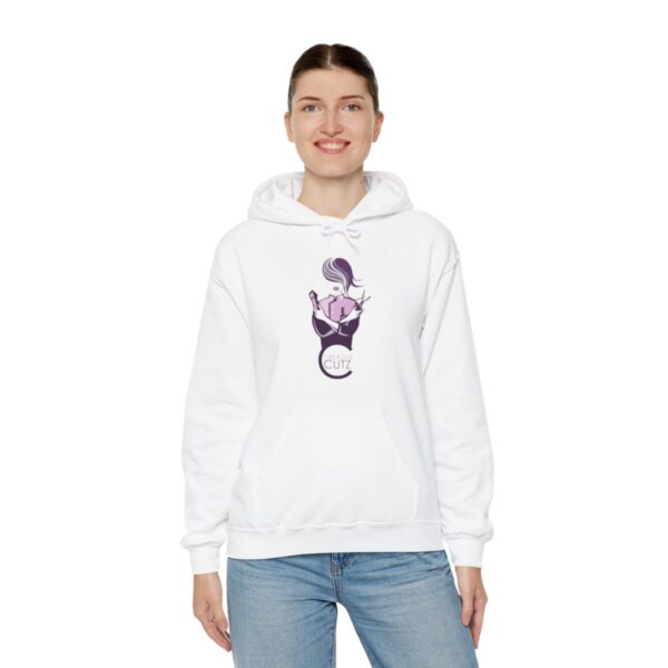 A woman wearing a white hoodie with an image of a person holding something.