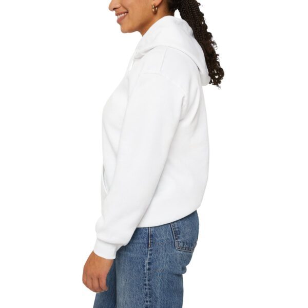 A woman wearing jeans and white sweater