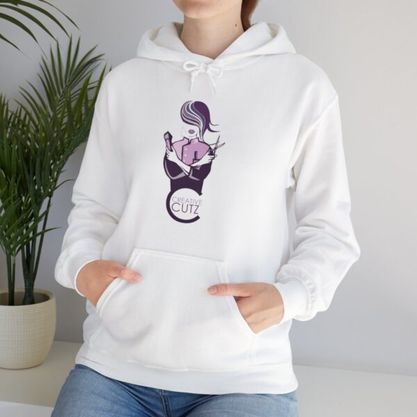 A woman wearing a white hoodie with a cat on it.