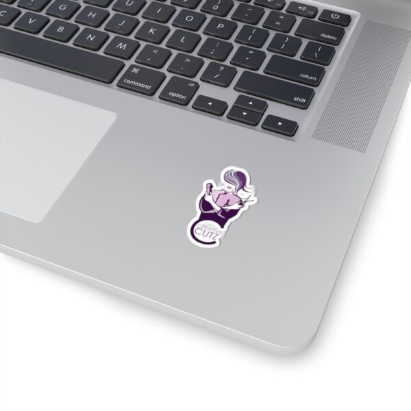 A laptop with a sticker of a monkey and a flower.