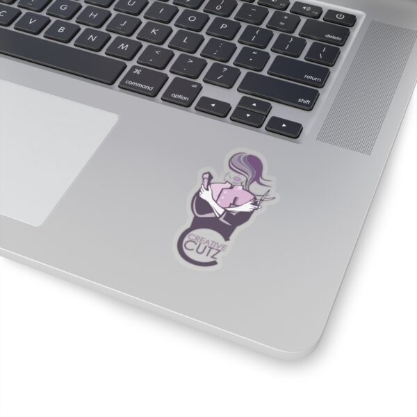 A laptop with a sticker of a person on it.